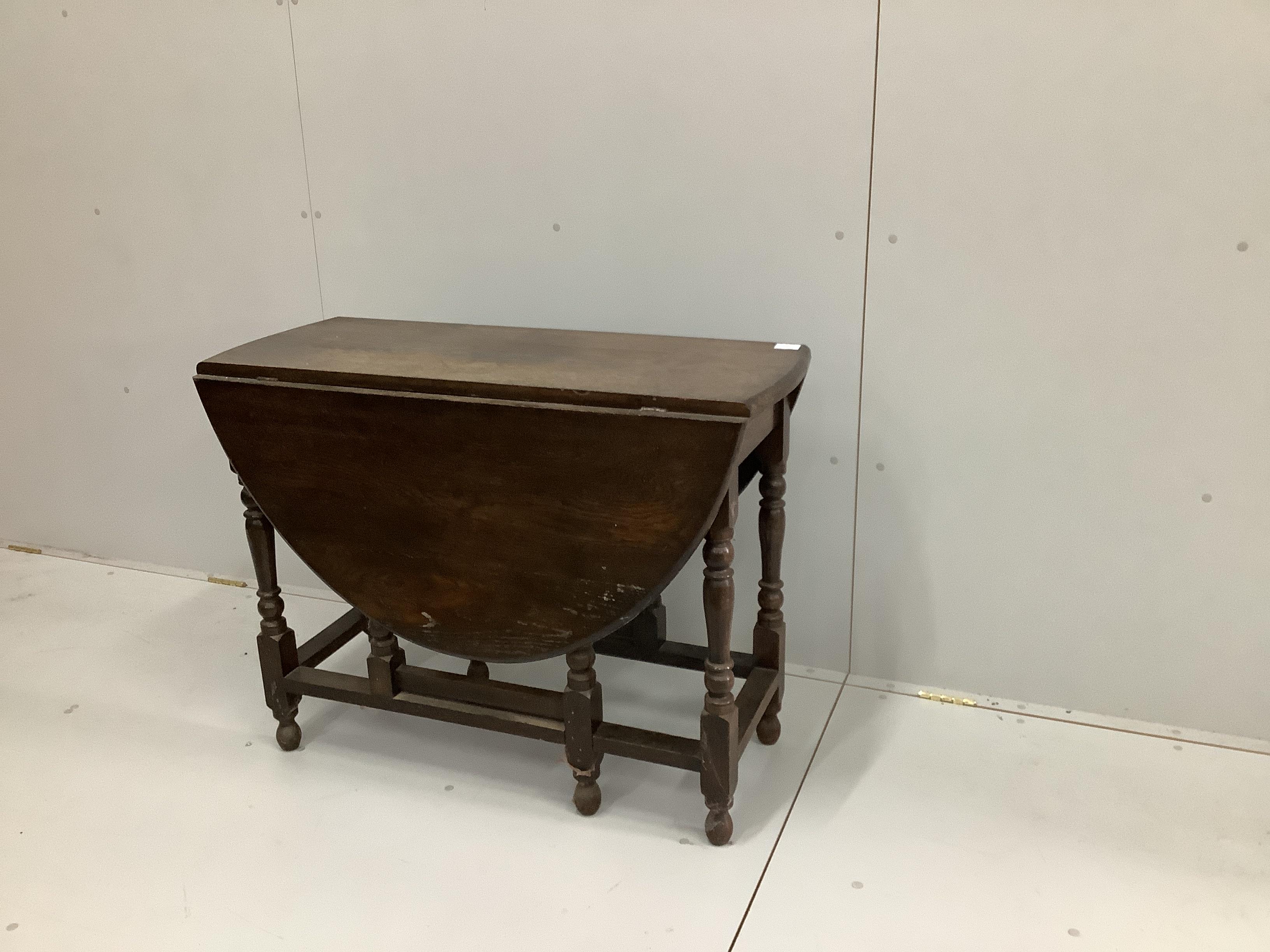 An 18th century style oak gateleg dining table, width 98cm, depth 42cm, height 75cm